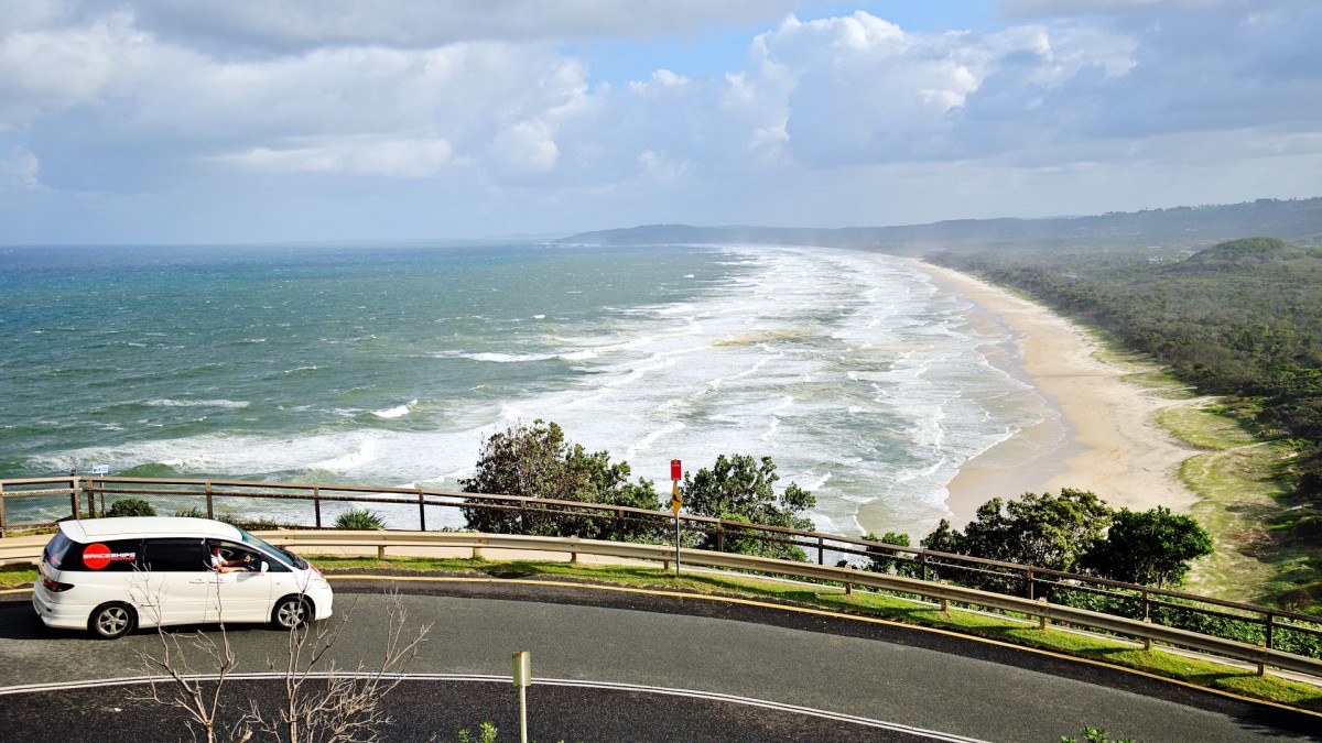 Campervan parked on the side of the road to enjoy the view of the ocean