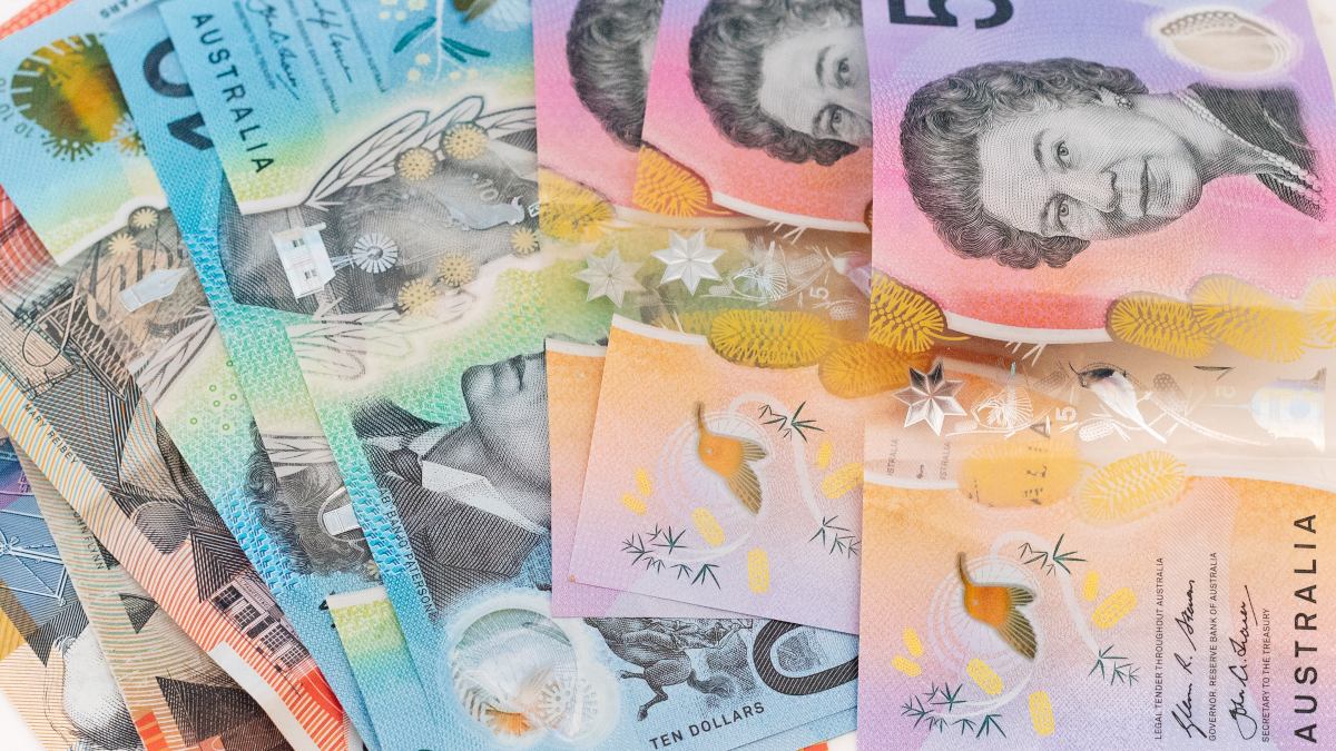 A pile of Australian Dollars spread out on a table