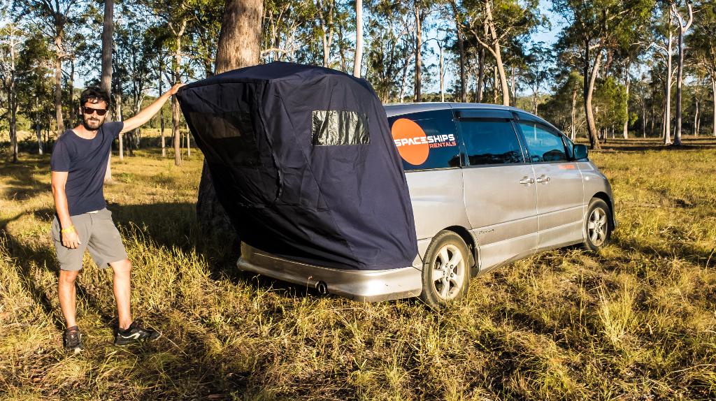 Campervan with rear awning set up - Proud Space Traveller standing next to it