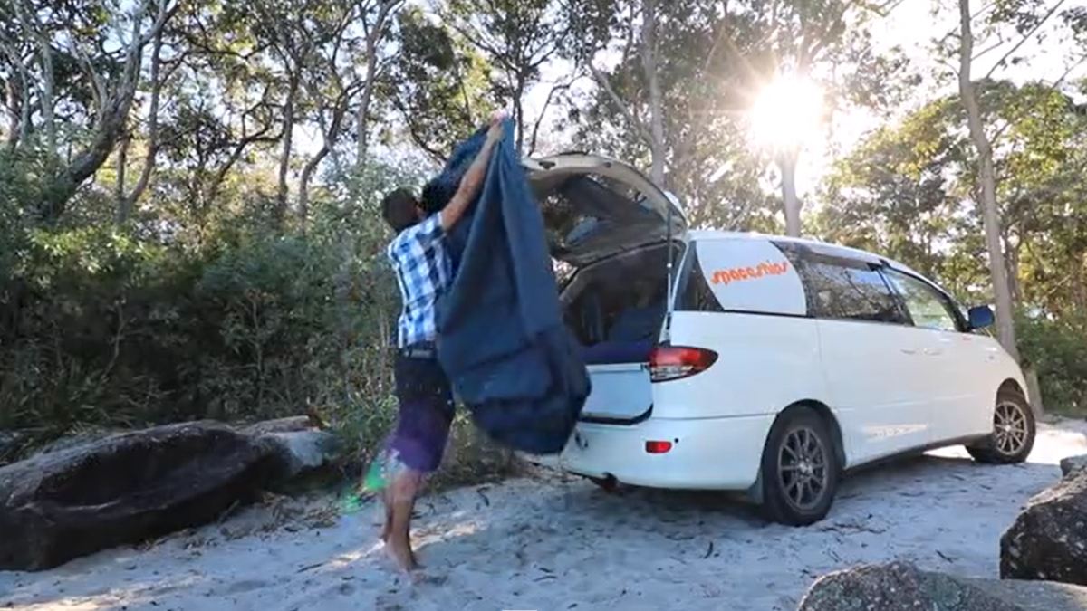 Space Traveller setting up the rear awning of the campervan