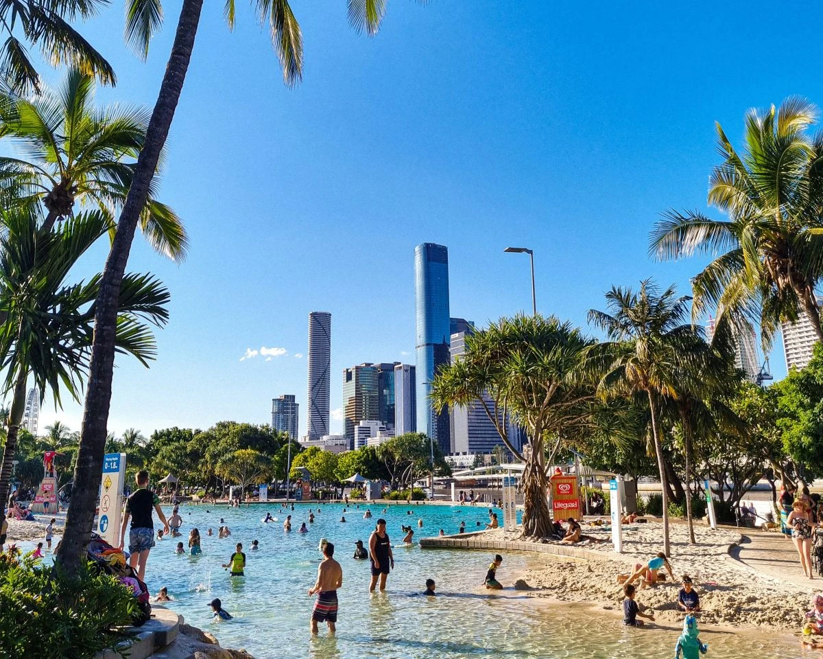 People swimming in a made made beach lagoon in the city