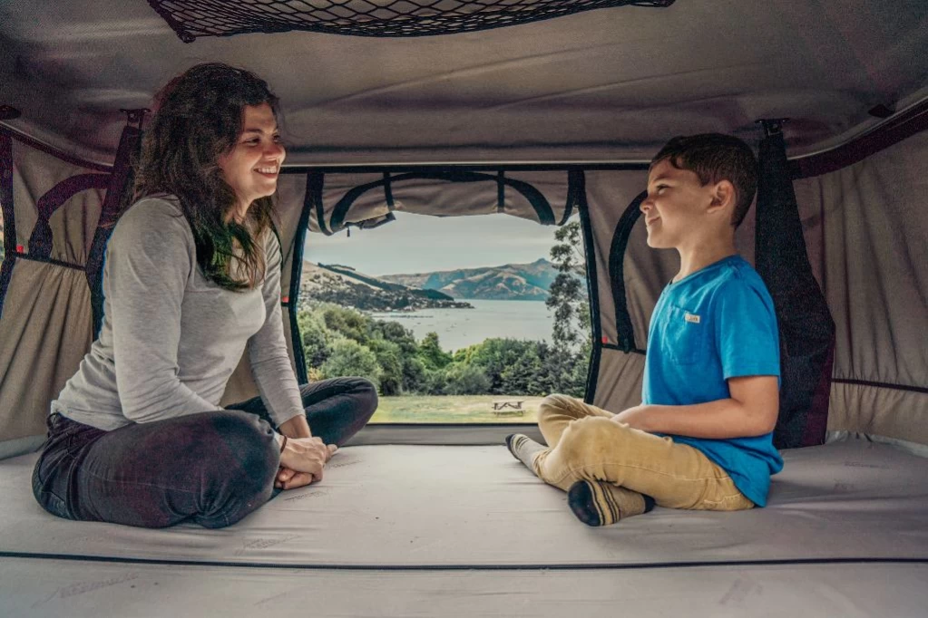 Mom &amp;amp;amp;amp;amp;amp;amp;amp;amp;amp;amp;amp;amp;amp;amp;amp;amp;amp;amp;amp;amp;amp;amp;amp;amp;amp;amp;amp;amp;amp;amp;amp;amp;amp;amp;amp;amp;amp;amp;amp;amp;amp;amp;amp;amp;amp;amp; kid sitting inside the rooftop tent of the Beta 4-berth campervan with rooftop tent