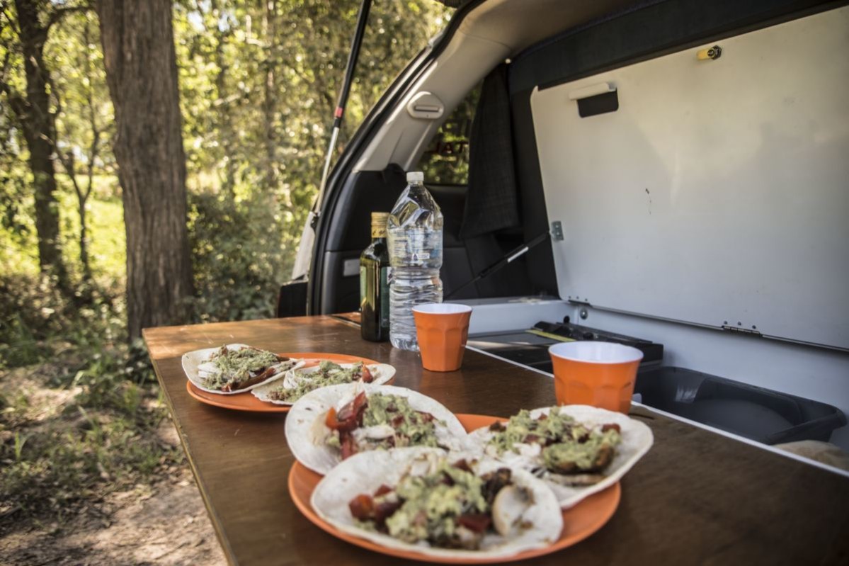 Delicious road trip tacos are ready - they're sitting on the cooking area of the campervan